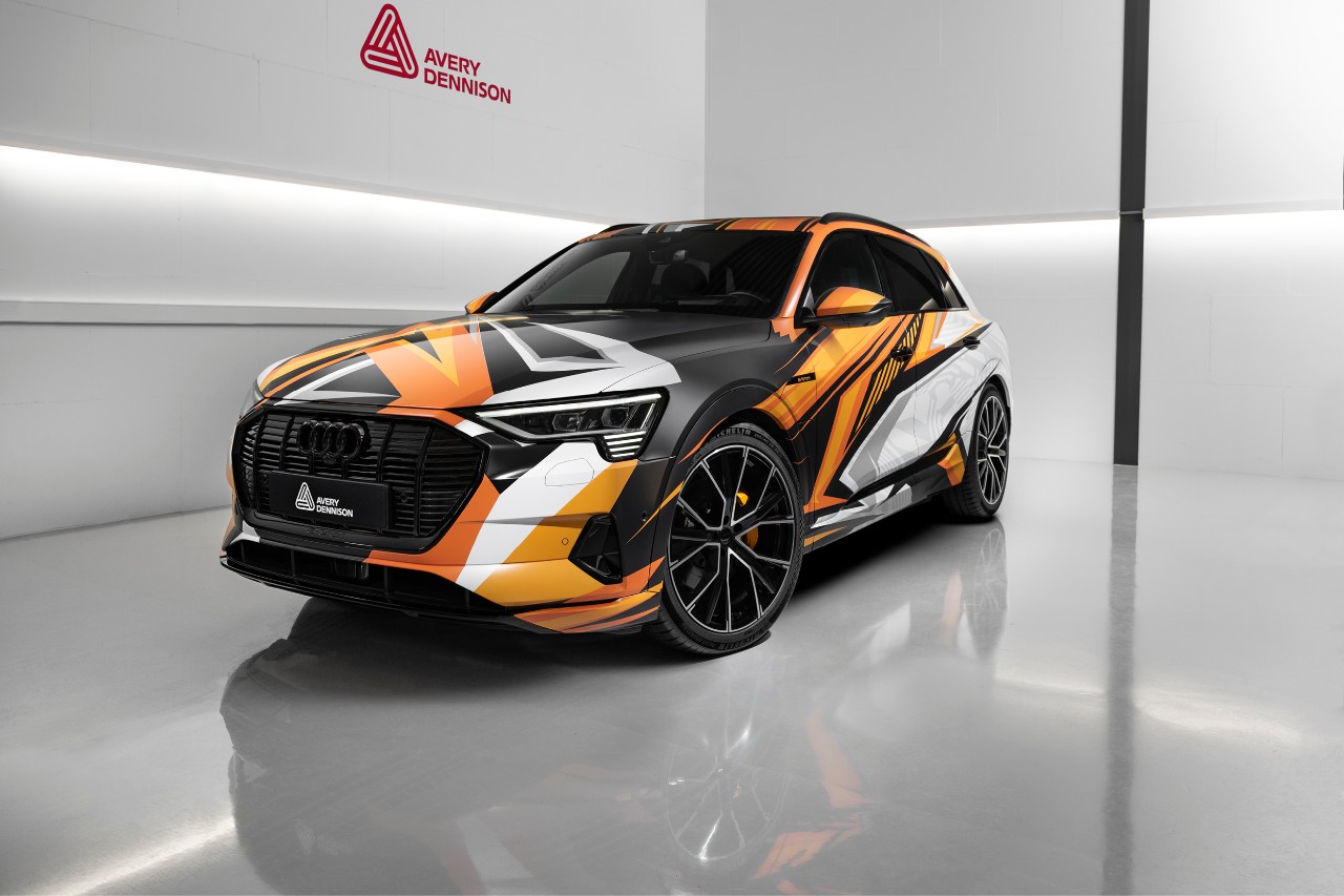 Orange, black and white Avery Dennison graphic wrap on an Audi